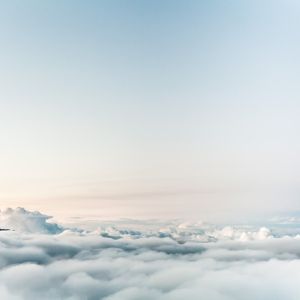 Photo of clouds and the very peaks of a mountain range