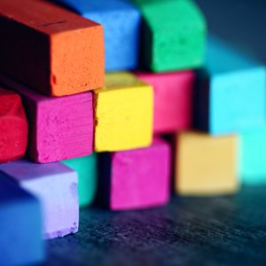 Colorful pastel crayons stacked on top of each other