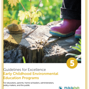 Close-up of pink rain boots standing near a snail