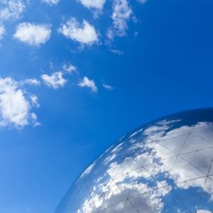 Fragment of the dome of the globe against the blue sky.
