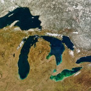 An aerial view of the Great Lakes, surrounded by a brownish landscape