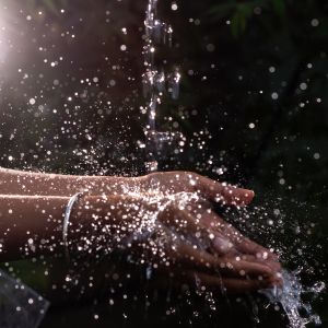 Human Hand Under Pouring Water