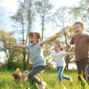 Kids running in a park on a sunny day