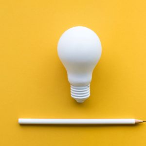 Creativity inspiration,ideas concepts with lightbulb and pencil on pastel color background.