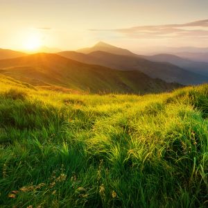 Sun rising over mountain range