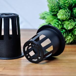 Black net pots for hydroponics growing media on wooden floor