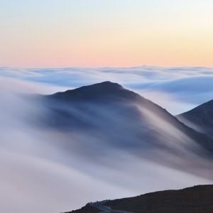 An inversion trapped low level moisture making for a stratus layerthat flowed over and around neighboring peaks.