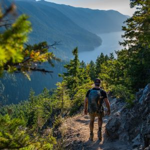man hiking through pacific northwest mountain trail