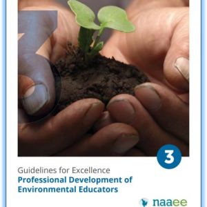 Macro photo of a pair of hands holding a seedling in dirt