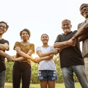 A group of people standing in a half-circle formation holding each other's hands