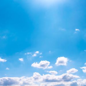 white clouds at horizon against blue sky