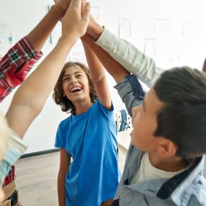 Group of junior high school students giving a group high five