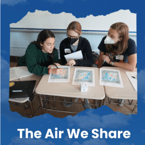 Three people, two of which are in masks, review maps of air quality data.