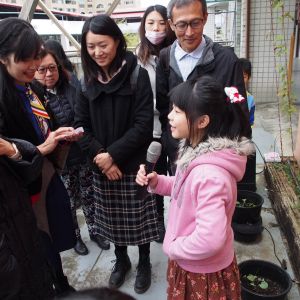 Young girl presenting to a group outdoors