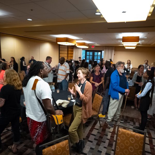 group of people conversing in conference room