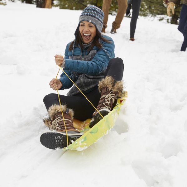 Woman on sled in the snow