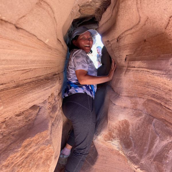 Irina Ayurzanaeva squeezing through the sandstone of Colorado National Monument