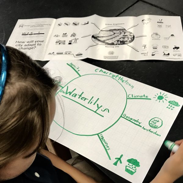 girl drawing chart of town