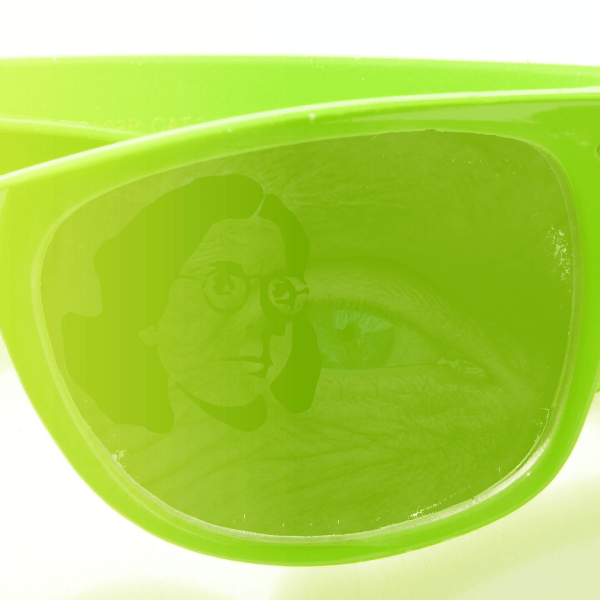 Image of glasses with reflections of a human eye and a graphic of a woman head.