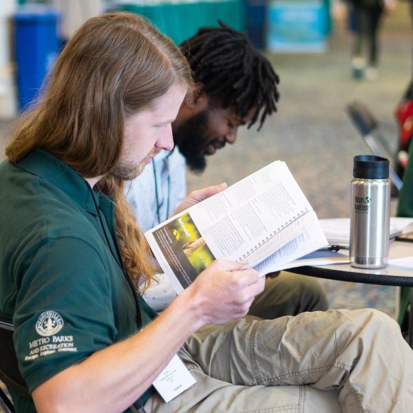 People reading books at a table
