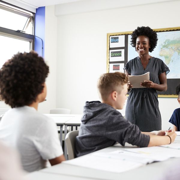 teacher and three students in classroom