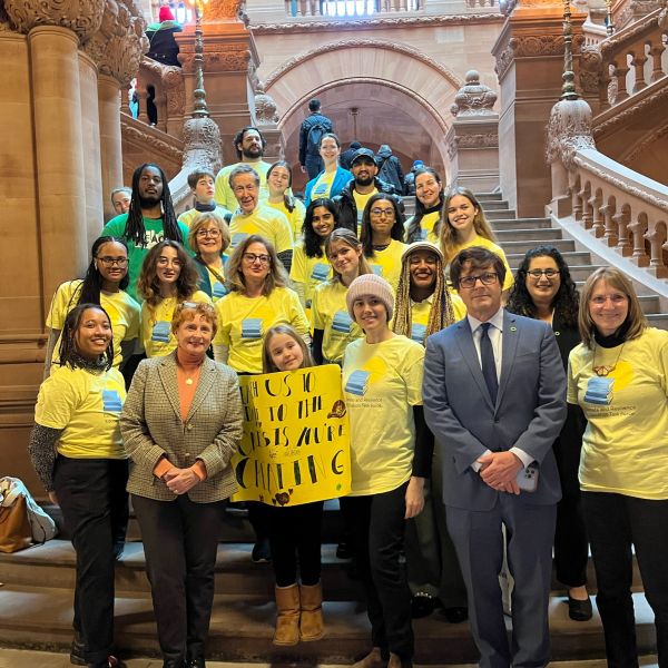 A group of people standing on indoors staircase