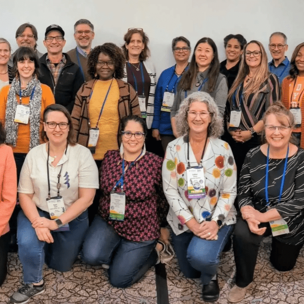 Group of people gathered around for a group photo