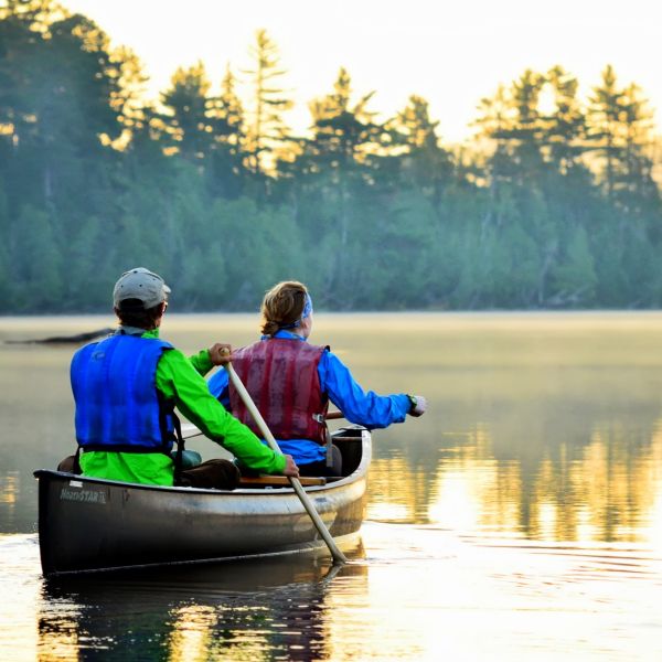 Two people in a canoe paddling on a lake