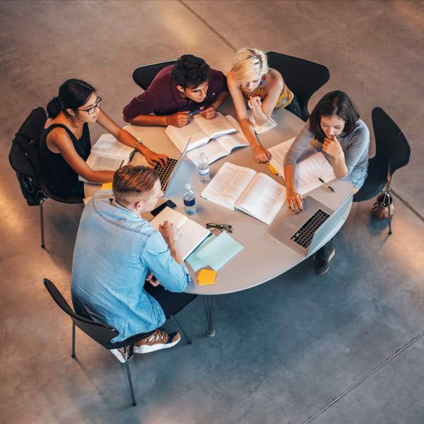Bird's eye view of a group of college-age students sitting around a round table