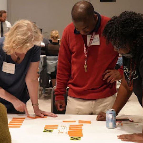 Group of participants gathered around a table during a science forum