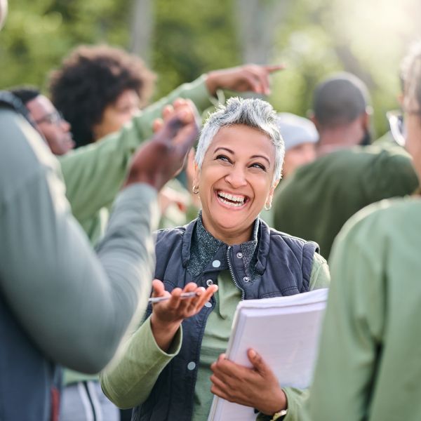 Woman with a clipboard talks to two people