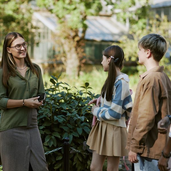 A teacher and three students outside