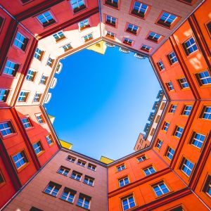 orange buildings making octagon at top with blue sky in middle